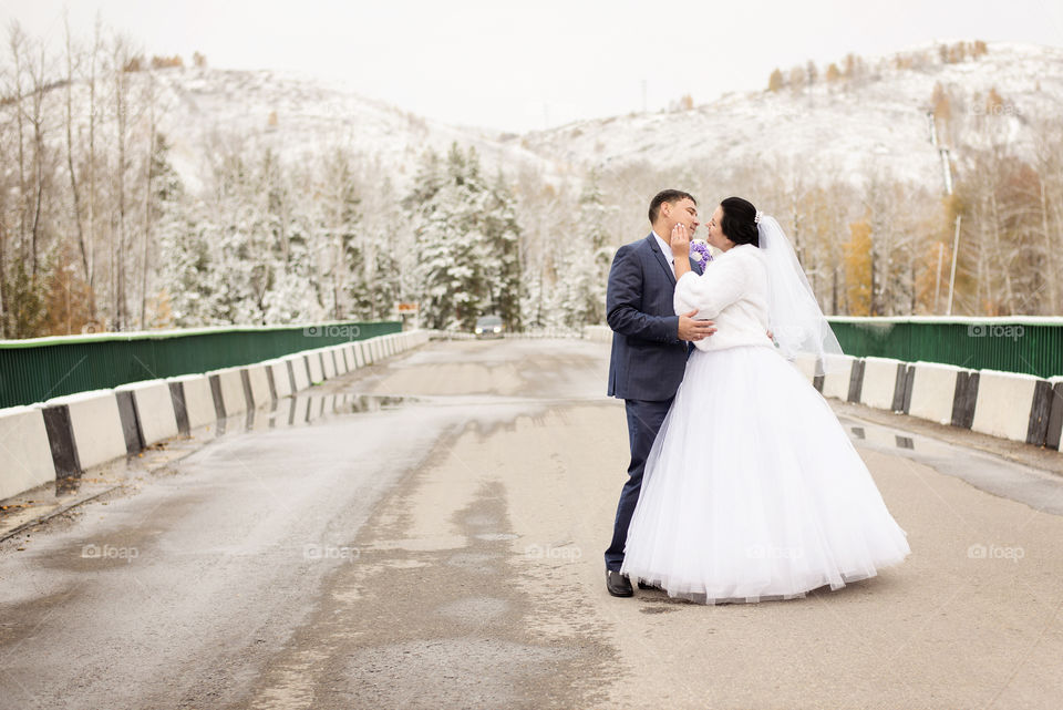 Beautiful wedding couple bride and groom at countryside road