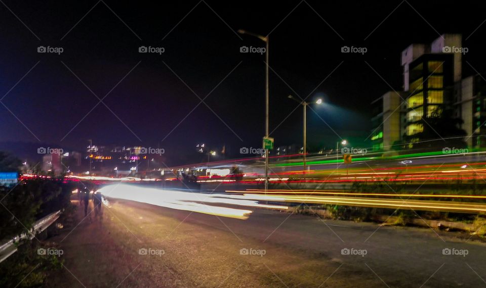 Light trail photography -it is urban life at night showing colourful light trail on highway.