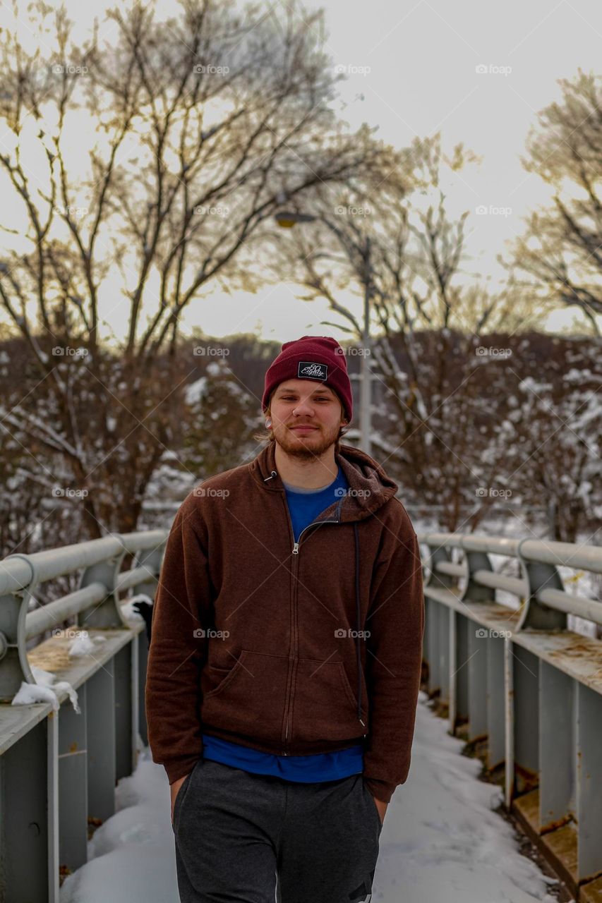 Handsome guy posing on a bridge 