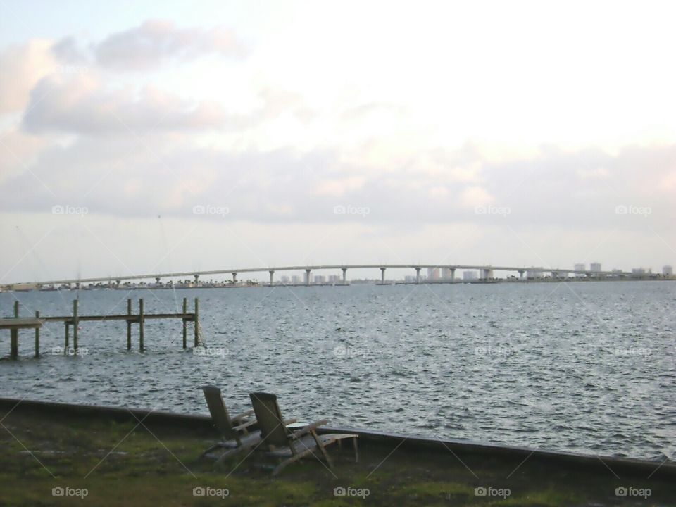 waterfront view. two old weathered lounge chairs with waterfront view of causeway