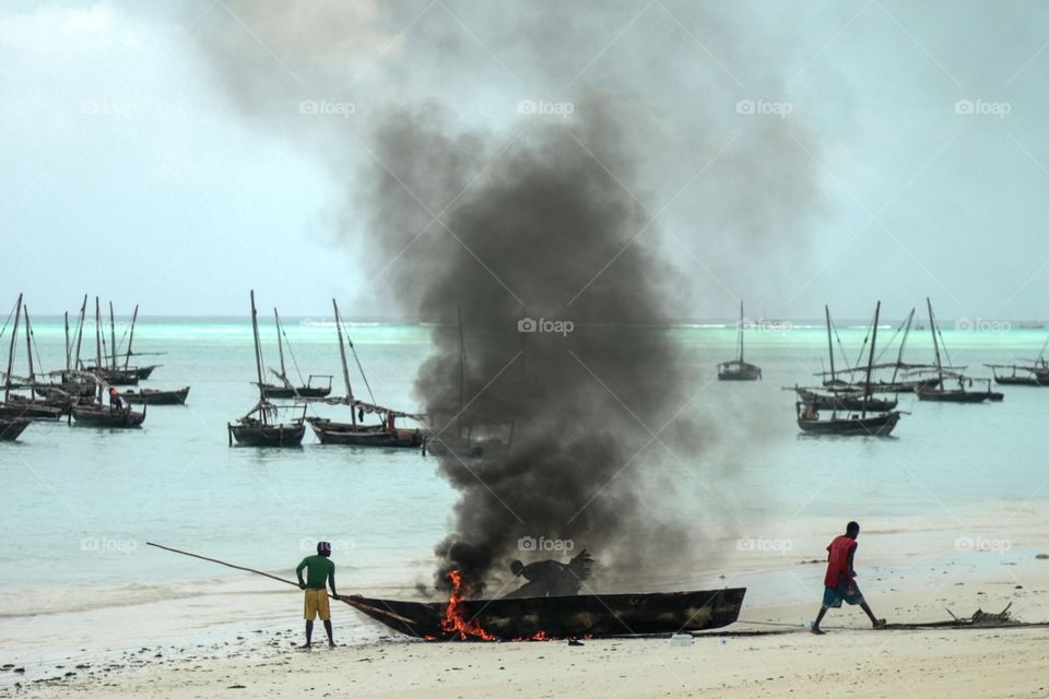 Burn baby burn. Fisherman of Nungwi Beach Zanzibar