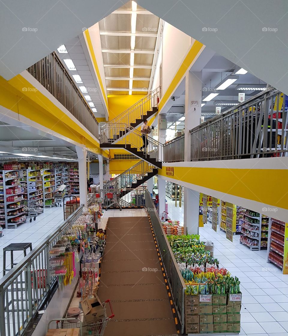 Shop stairs in four-storey buliding, conventional stairs, climbing stairs on foot, limited by stair railings,