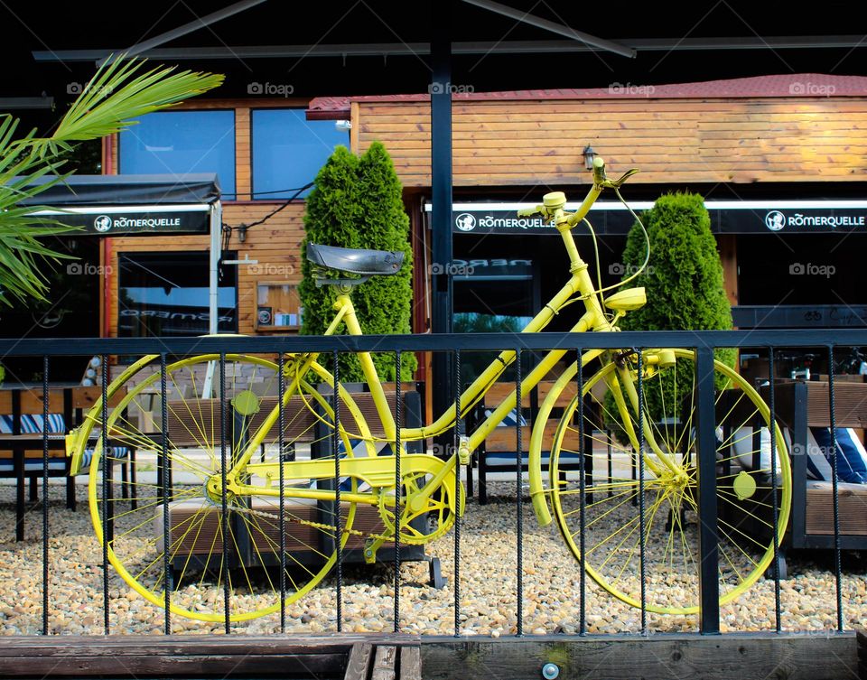 View of the one lonely old yellow bicycle as a decoration in front of the restaurant