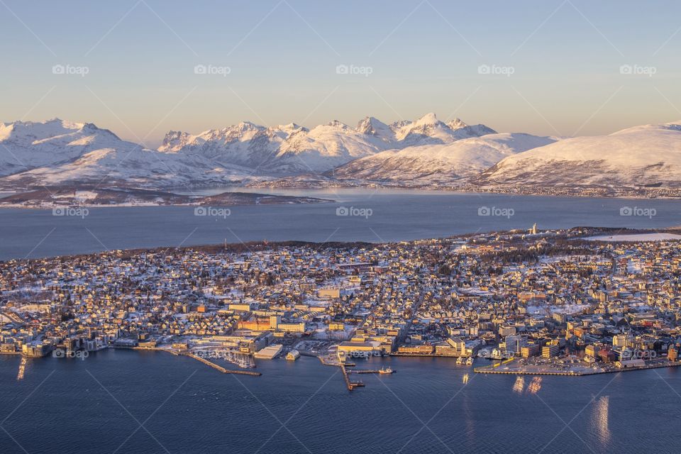 View of city near snowy mountain and sea