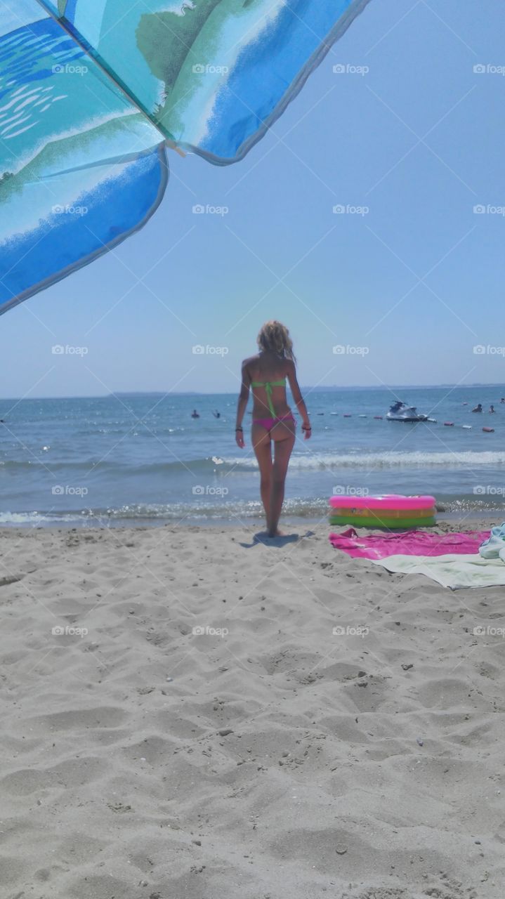Rear view of a woman walking on beach