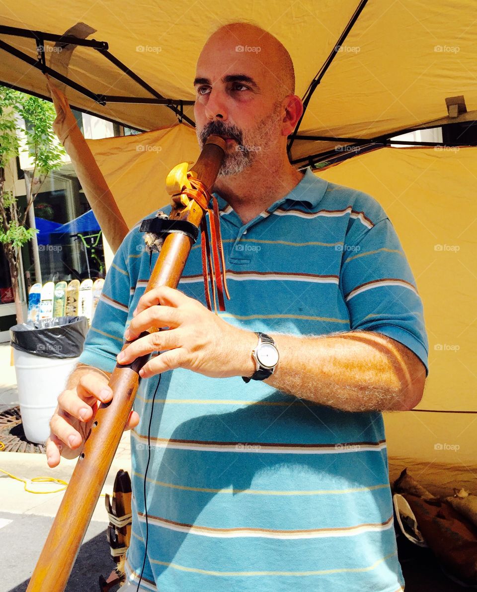 Man Playing  Hand Carved Flute