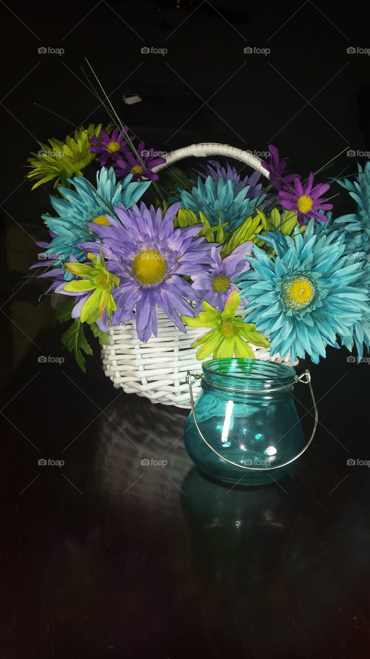 colorful flower basket and blue glass vase