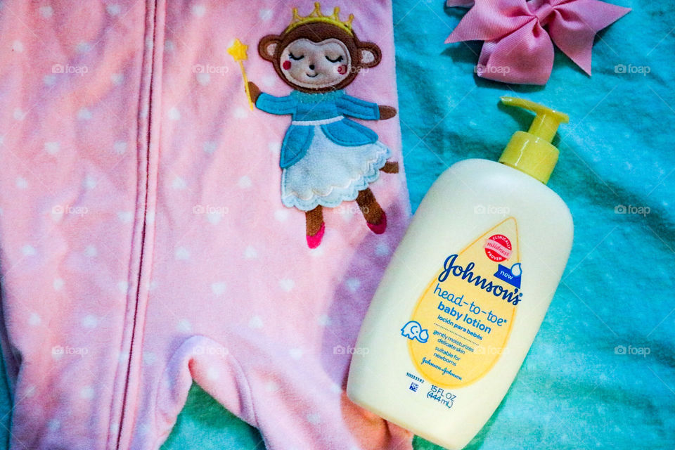 Johnson’s Baby lotion and cute pink Onesie.