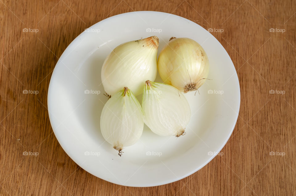 Onions In White Plate On Wooden, Table