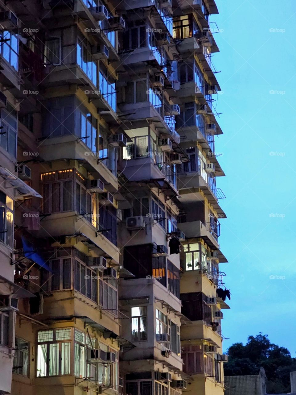 Evening, light from home of families lighting up, seen through their windows