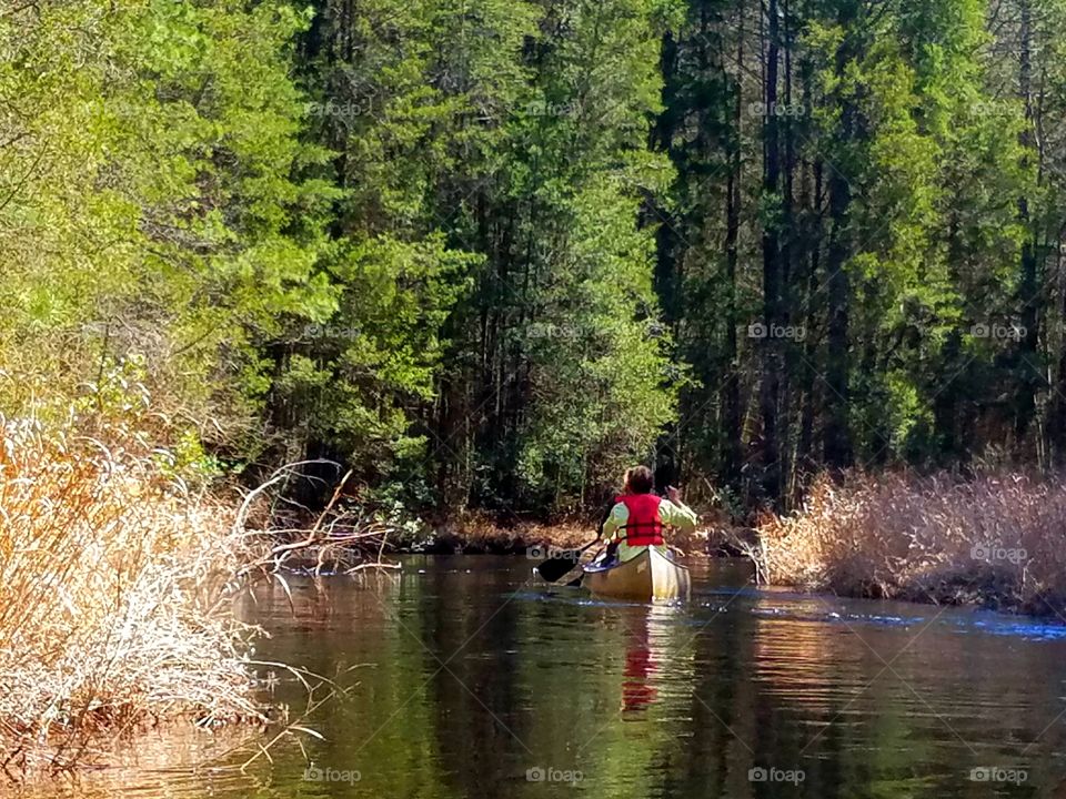 lovers canoeing on a sunny spring day