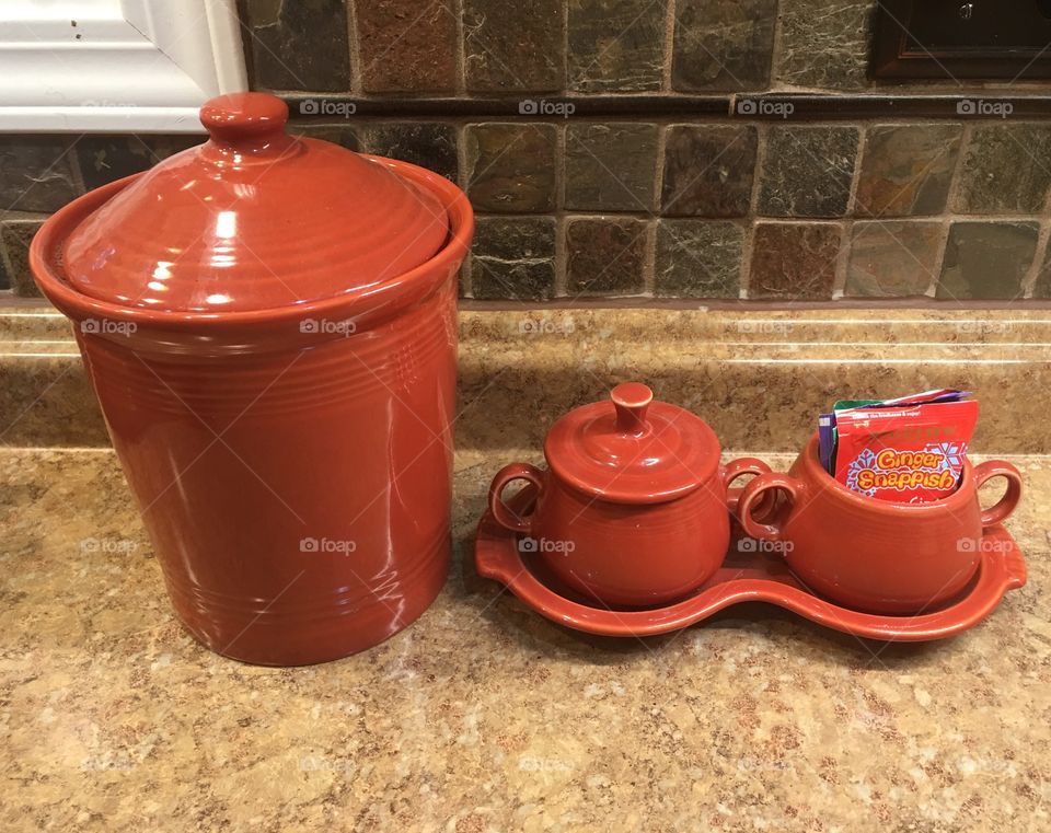 Matching ceramic coffee, sugar,  and tea containers. 