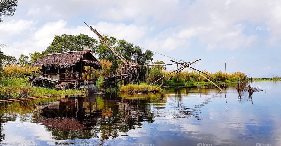 Scenic view of waterfront against blu sky