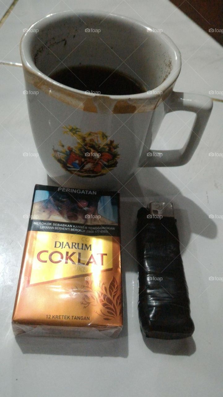 a cup of black coffee and a cigarette