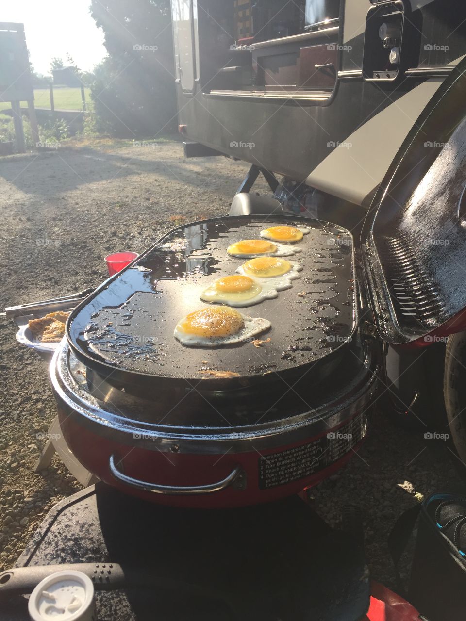 Sunny side up. It's breakfast at the campground. People are starting to stir, bacon is cooked, eggs are on and the coffee is brewing