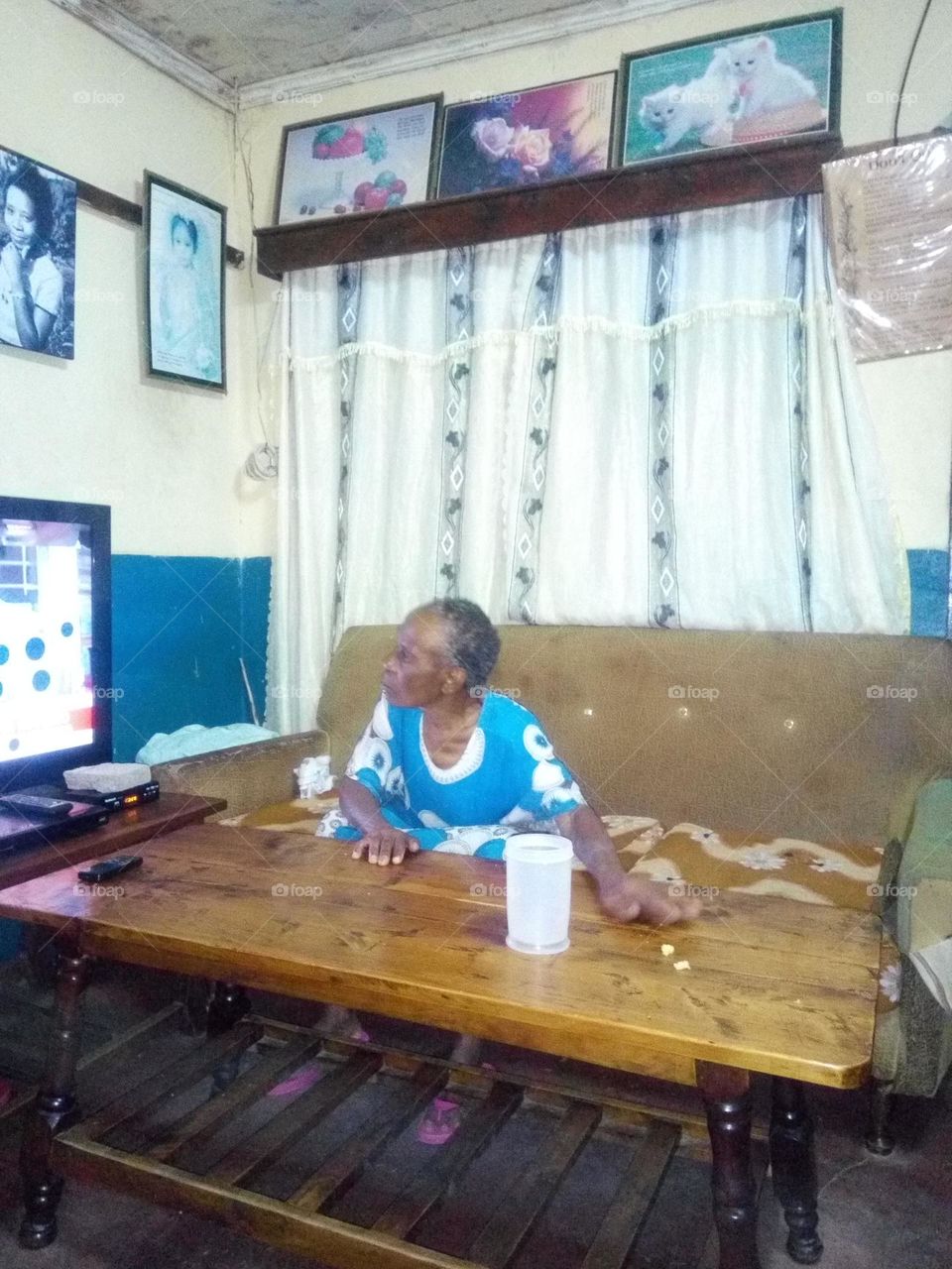 Beautiful, strong, happy and healthy old mother watching television.