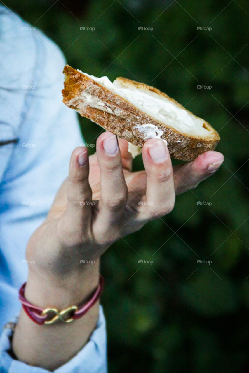 Person holding bread and butter