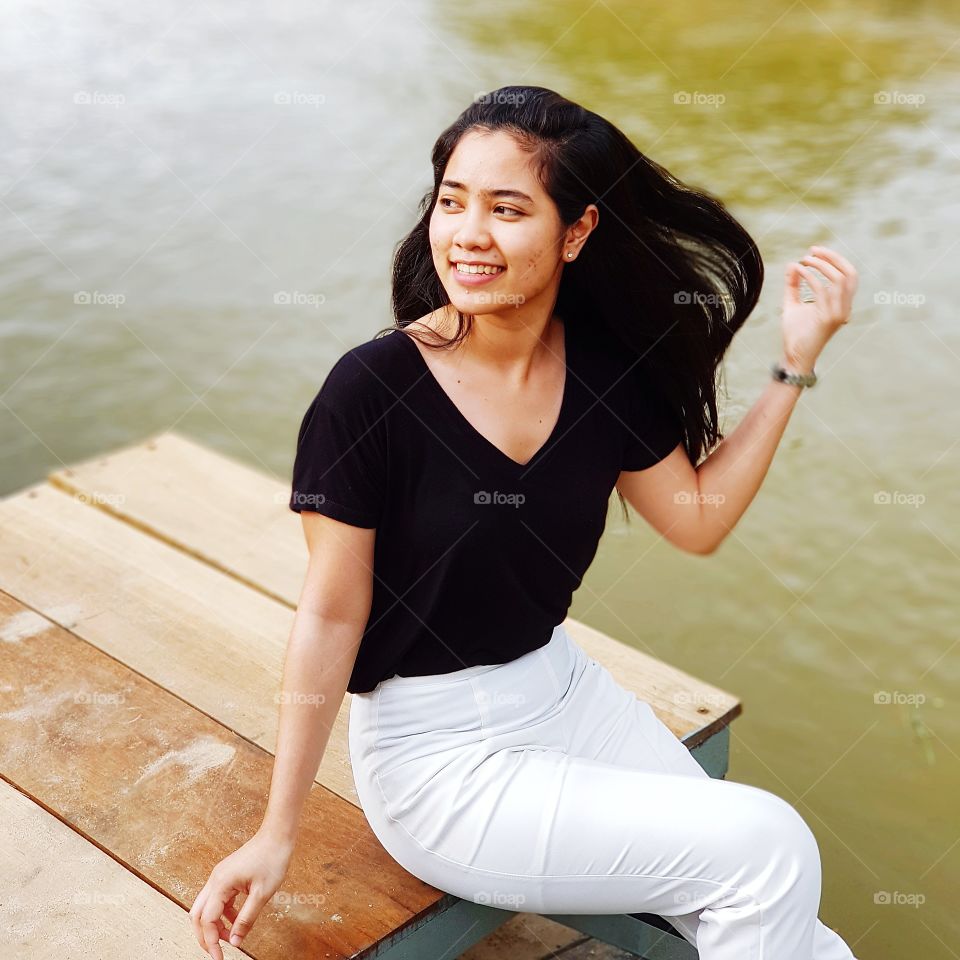 Smiling Asian girl at riverside
