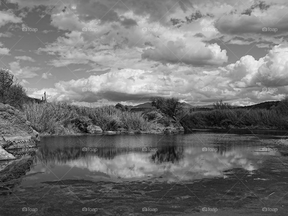 A black and white image of the Salt River region near Phoenix Arizona illustrates a beautiful reflection of the numerous clouds