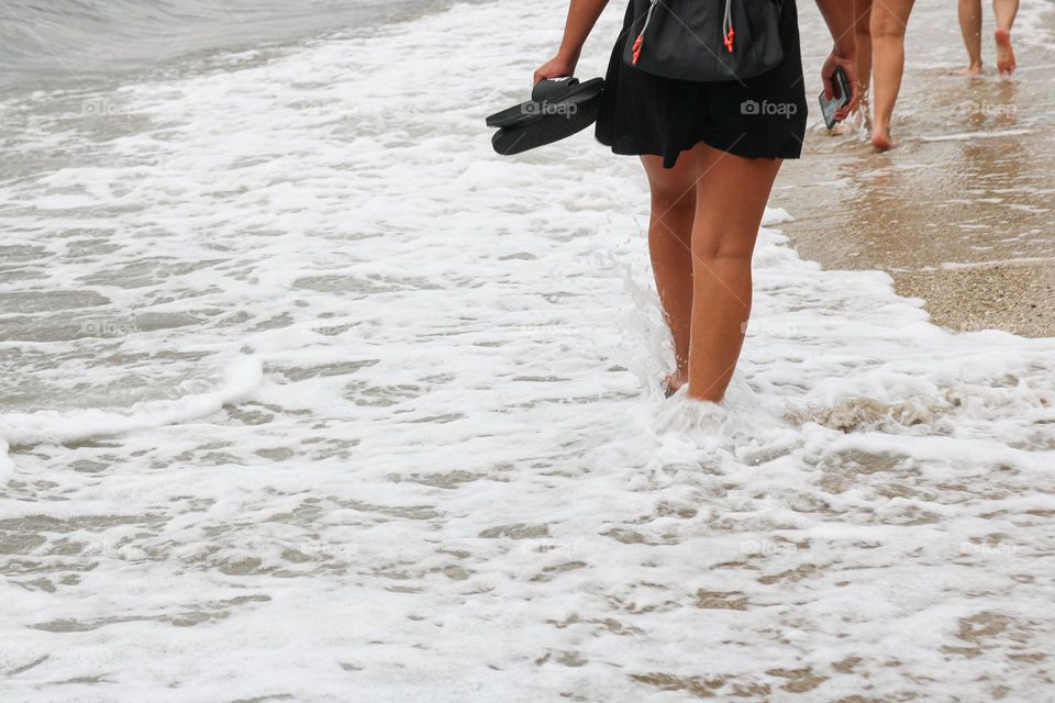 A girl walks on the beach