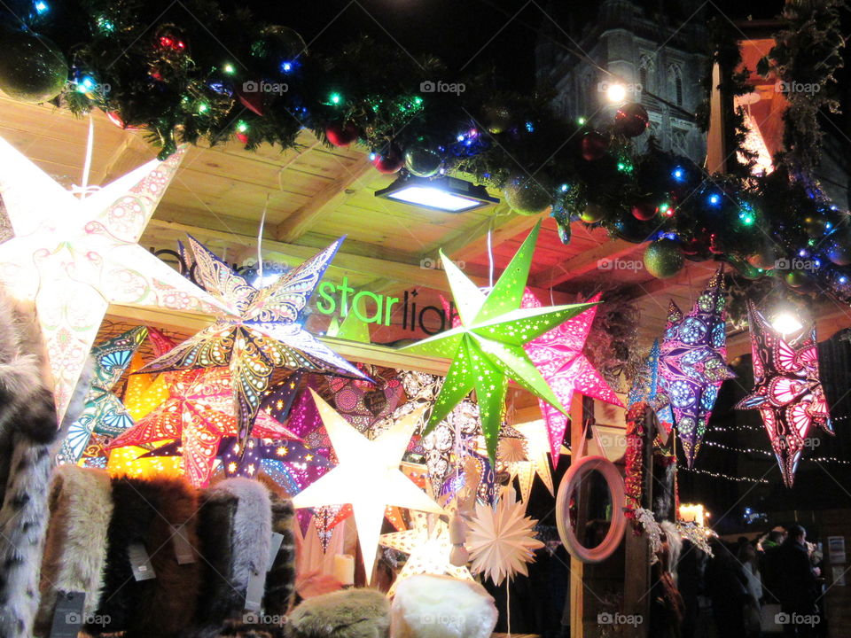 Christmas market at Bath. Stall selling colourful lights in the shape of stars