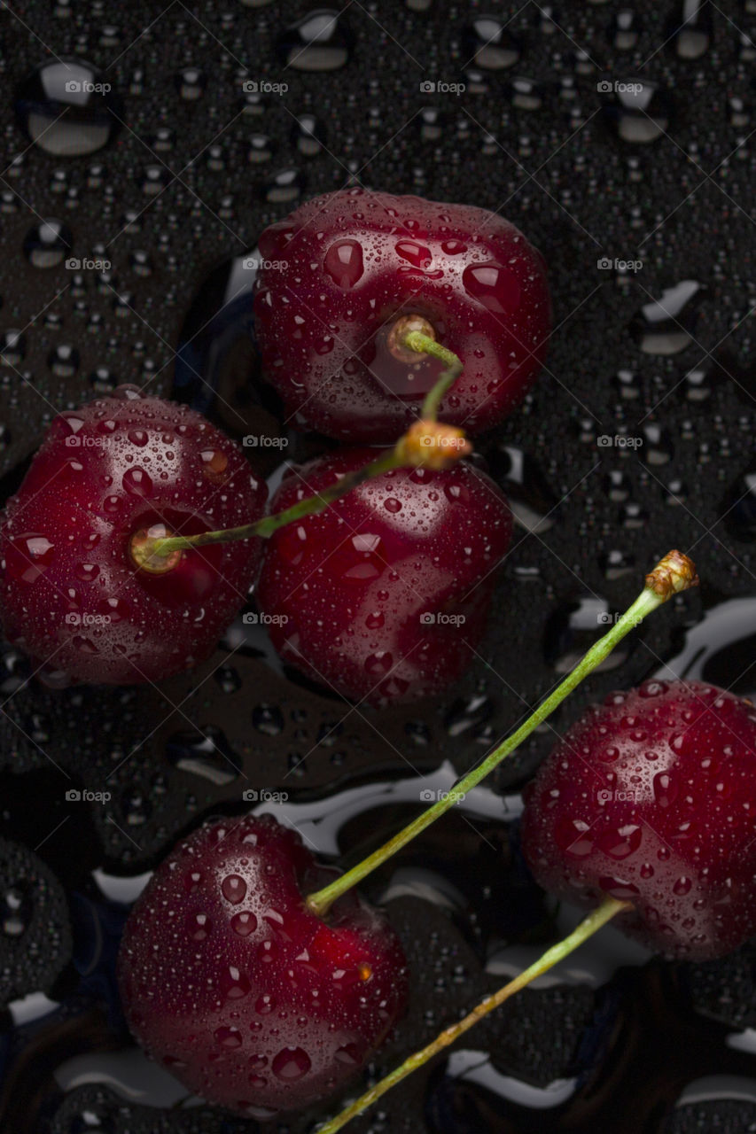 macro shot of red sweet cherry covered with water drops . Top view.  red color concept