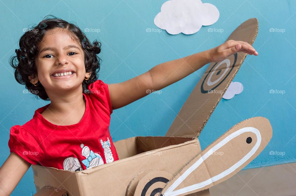 Happy girl playing indoors.