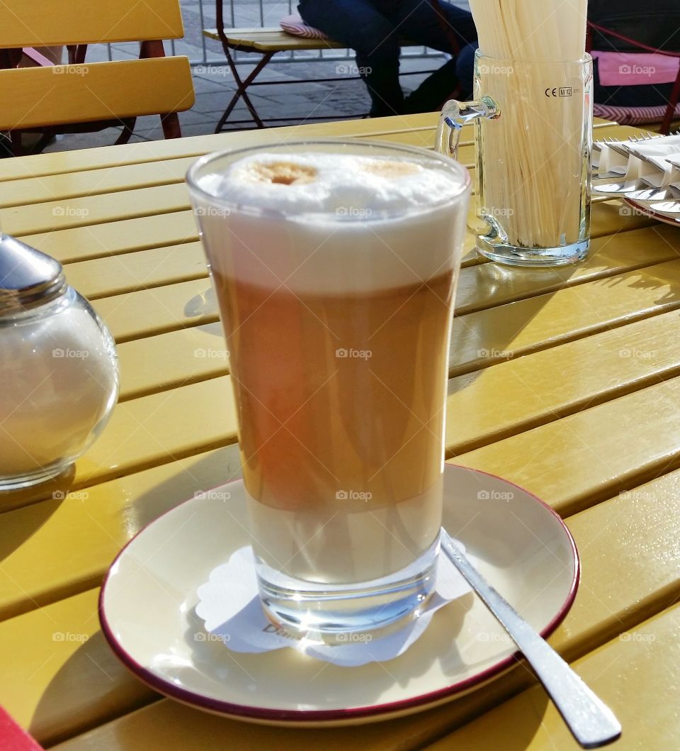 Latte in the morning. I took the photo of my wife's latte. We usually stop at the same place on our walking route and have a latte.