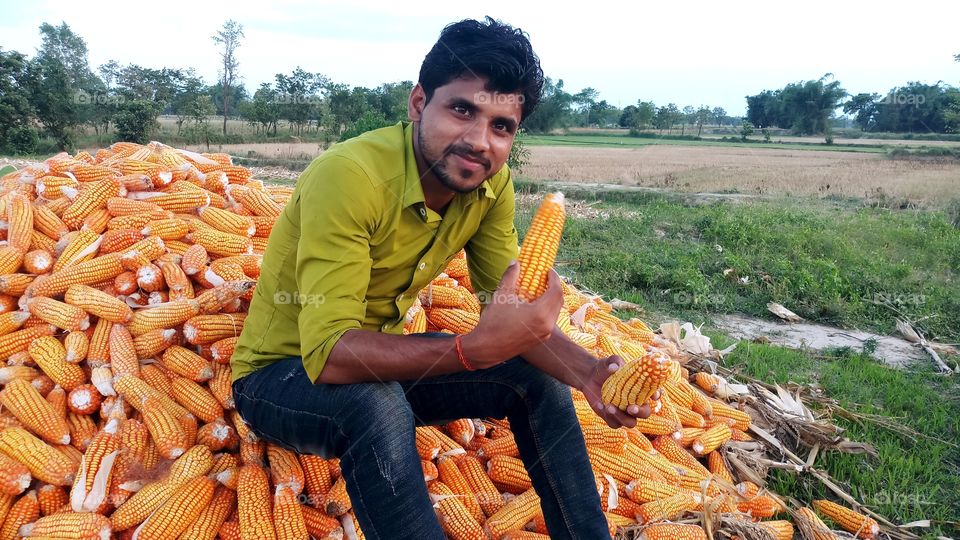 happy farmer with maize