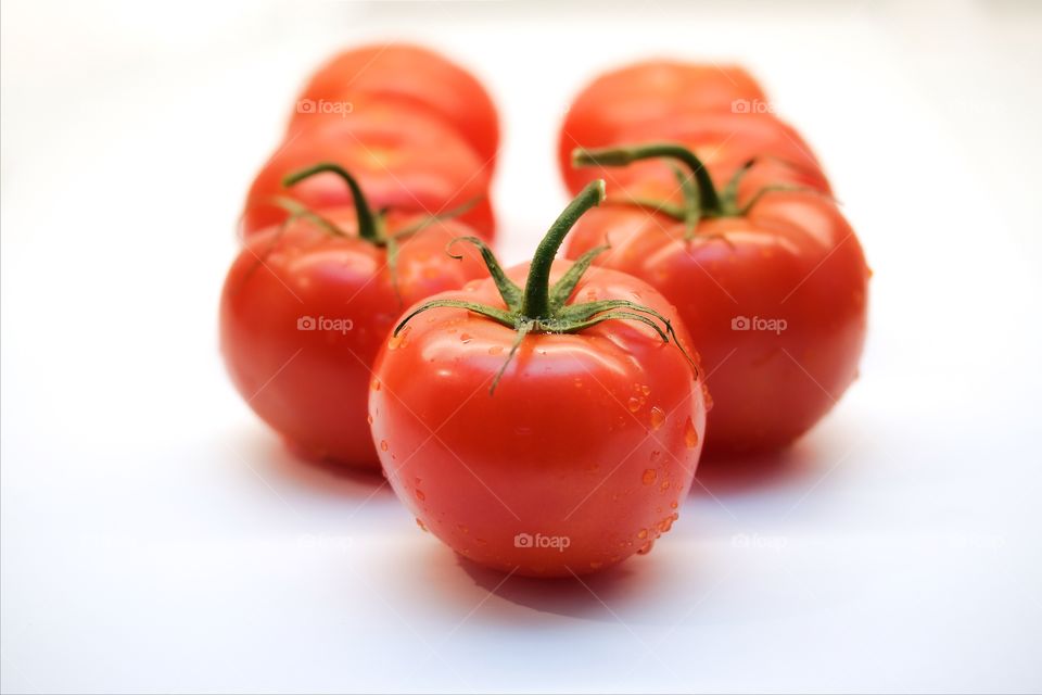 Tomatoes over white background