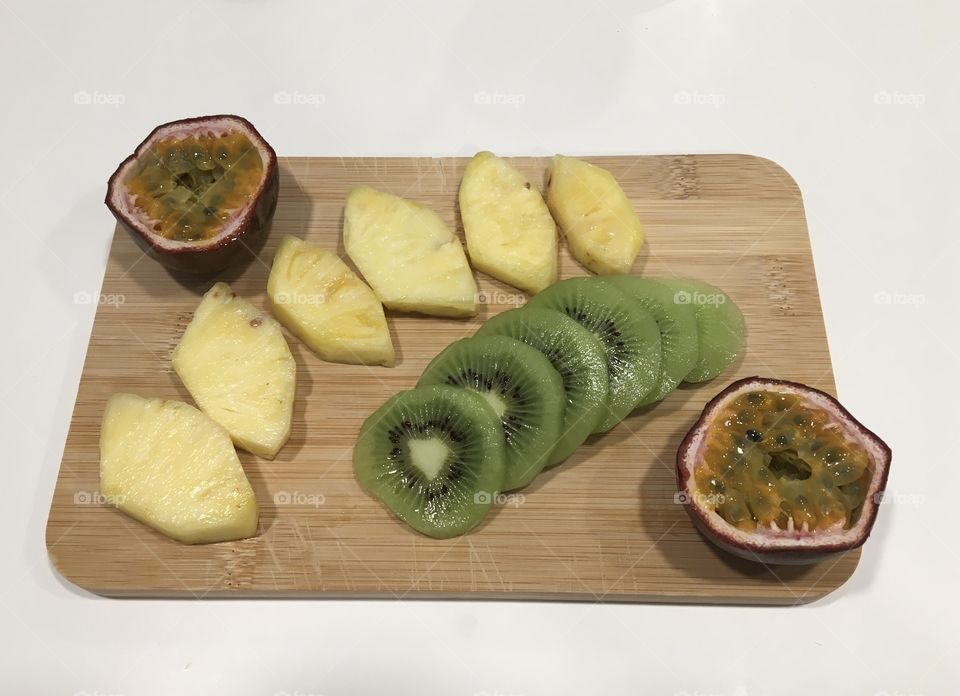 Flat lay with fruits ready to eat on wooden tray