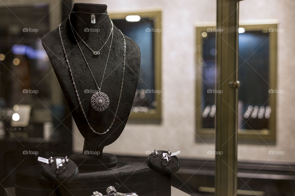 jewelry medallion close up through window showcase