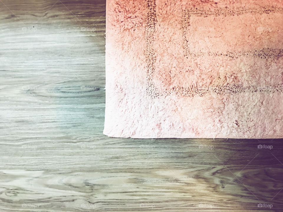 Pink rug and wood floor