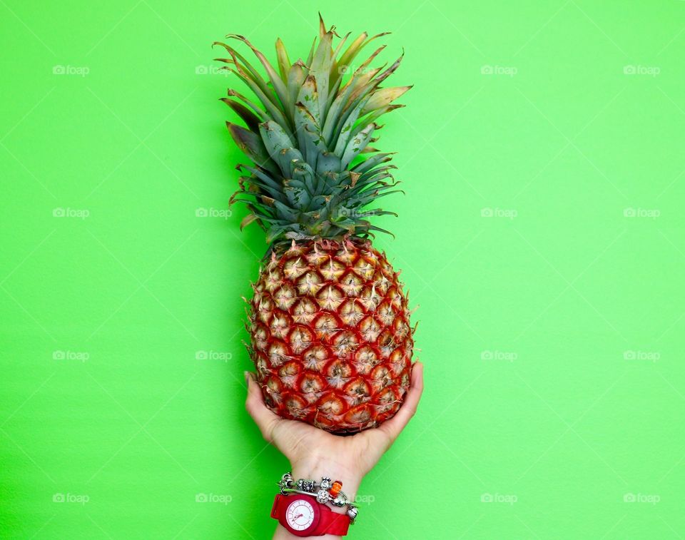 Close-up of pineapple on green background