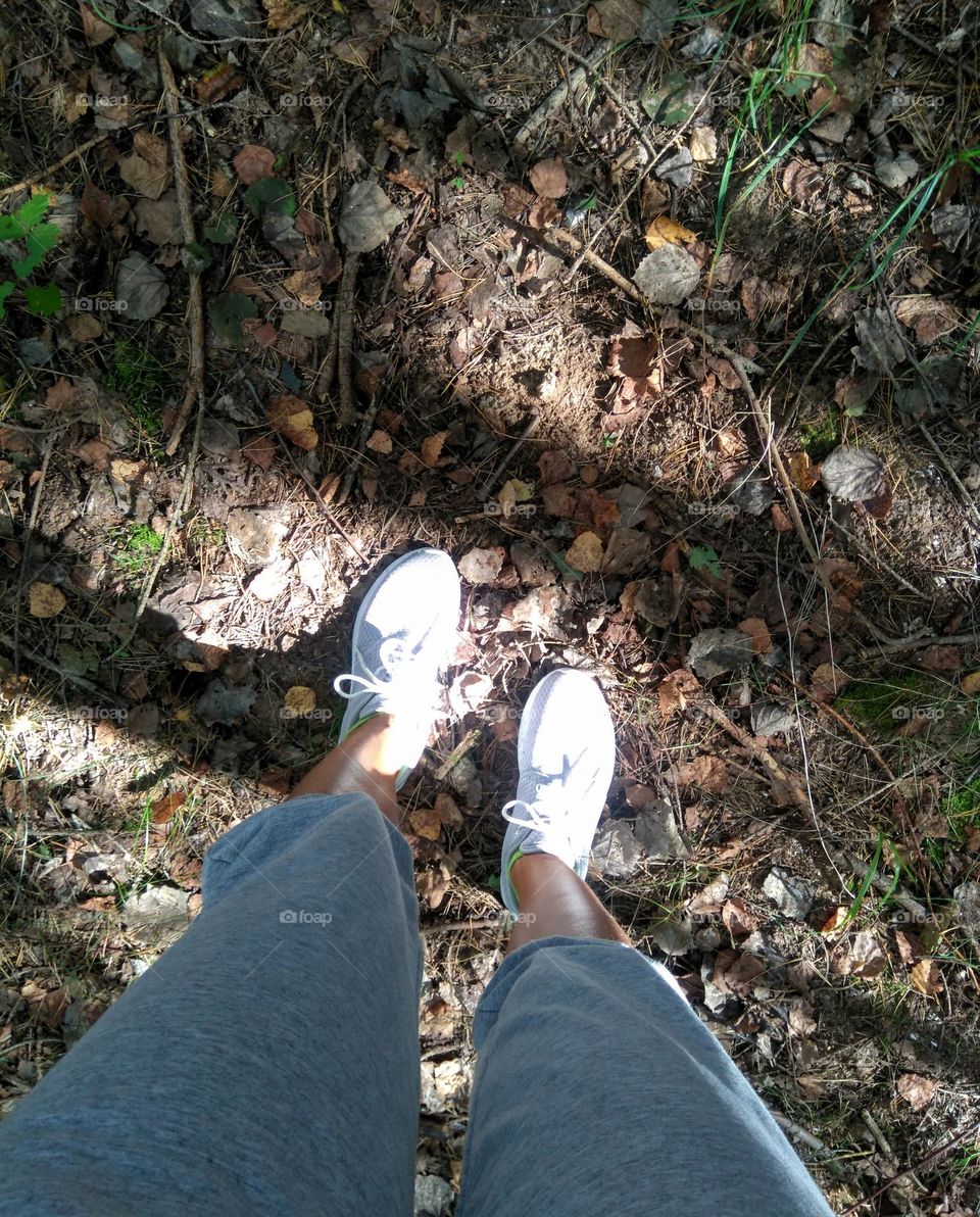 female legs shoes top view beautiful earth background in sunlight and shadows