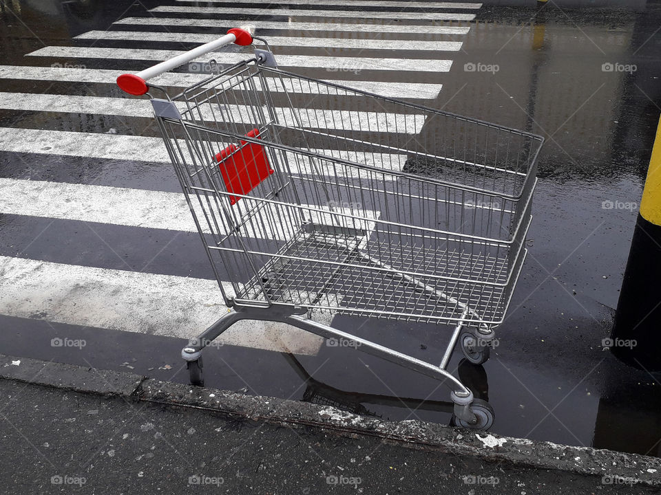 Carts for grocery products stand near a supermarket on the street