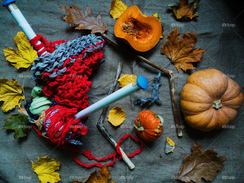 pumpkin, autumn leaves and knitting on the table