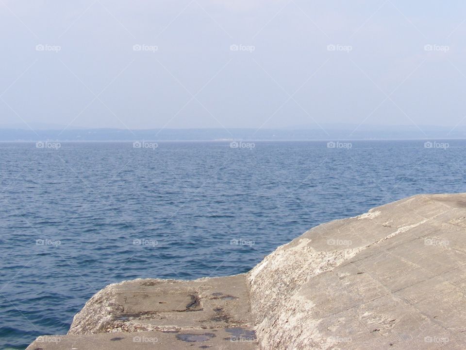 A view of Lake Michigan from atop a concrete structure 