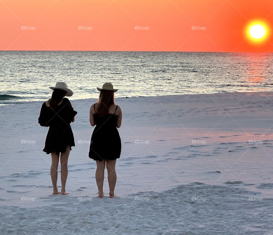 Cowgirls on the beach enjoying the January sunset on the Gulf of Mexico - If you are in a beautiful place where you can enjoy sunrise and sunset, then you are living like a king or queen.