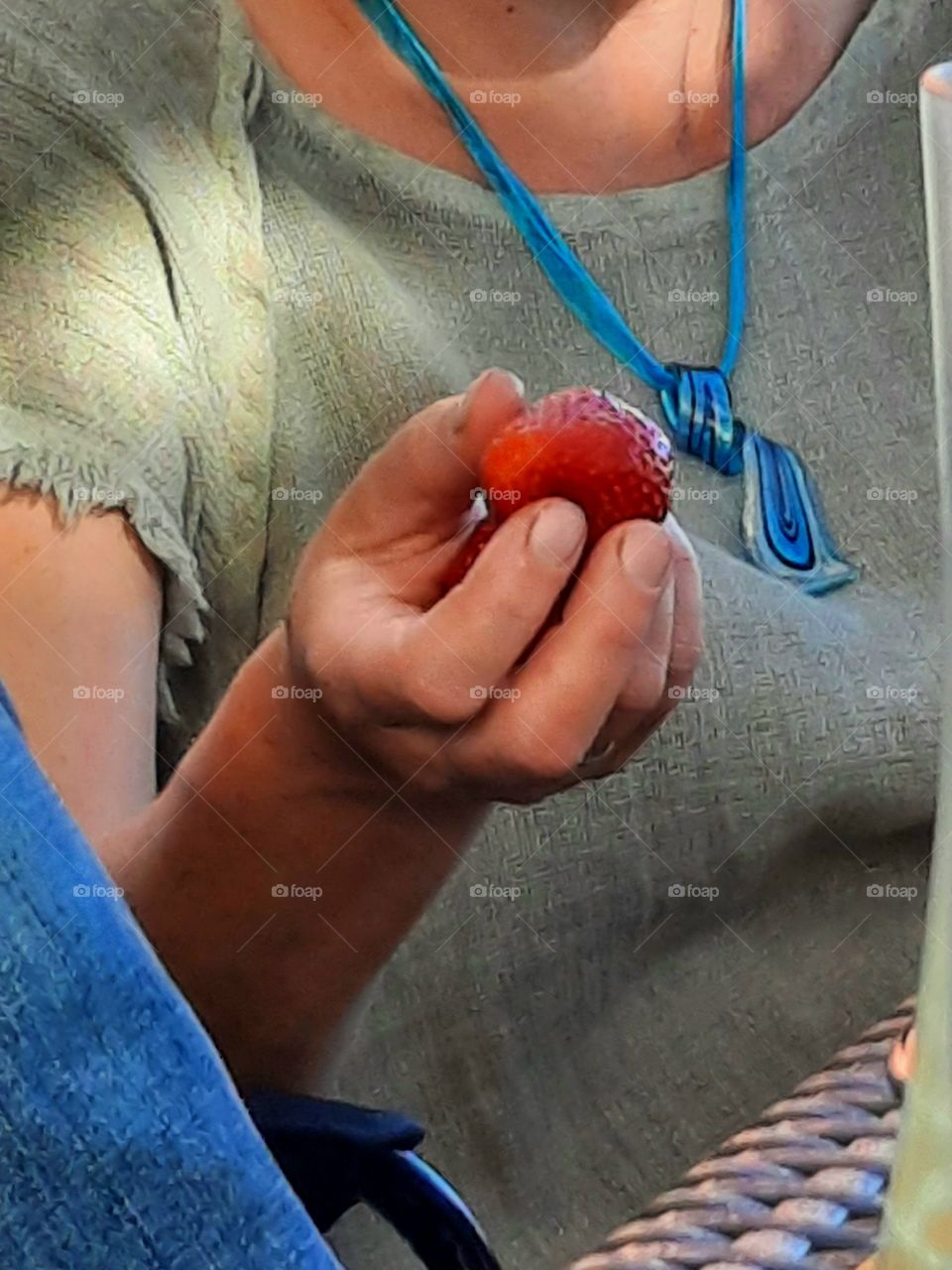 red strawberry in  woman's hand