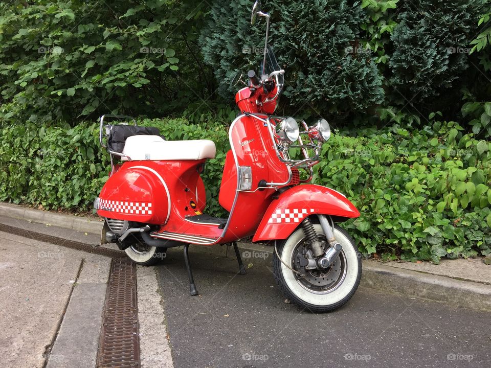 Red scooter with a white seat