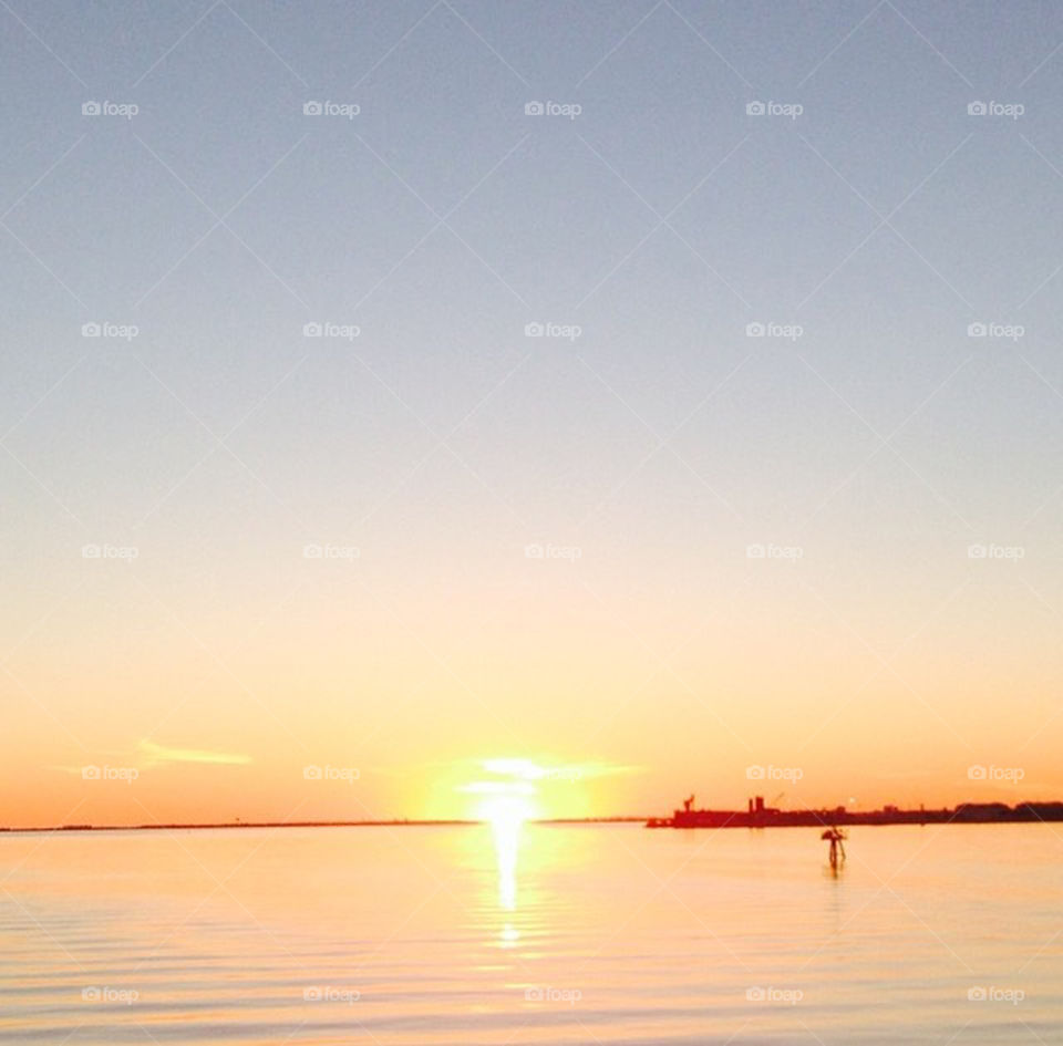 Sunset over Pensacola Bay. My husband and I were driving to dinner and stopped to take this gorgeous sunset of the sunset over Pensacola Bay.