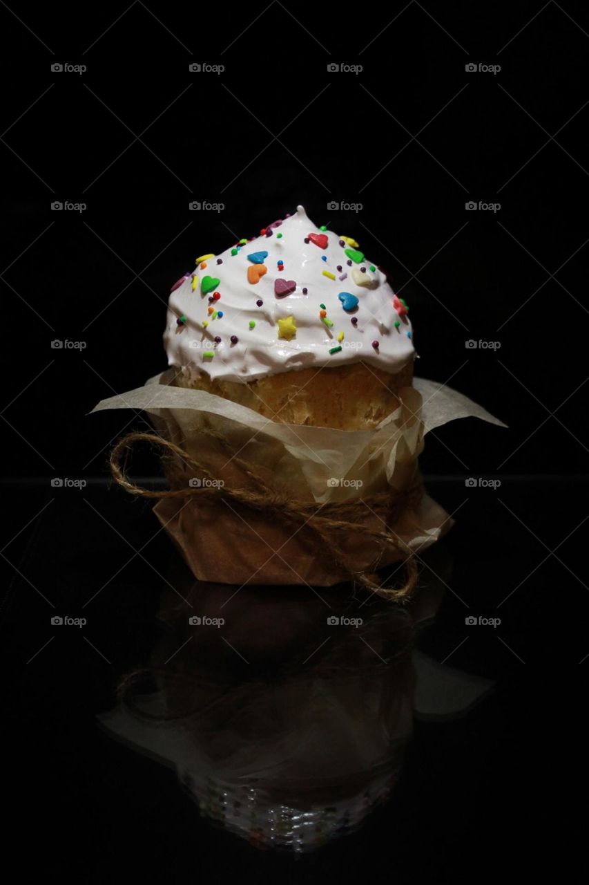 Easter cake on the dark background wrapped in paper with a rope