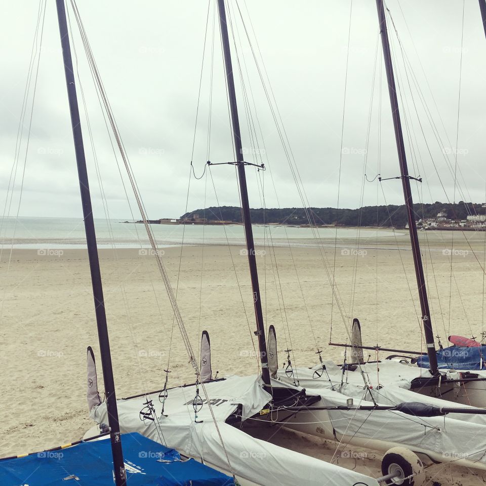 Yachts white sand and grey skies 