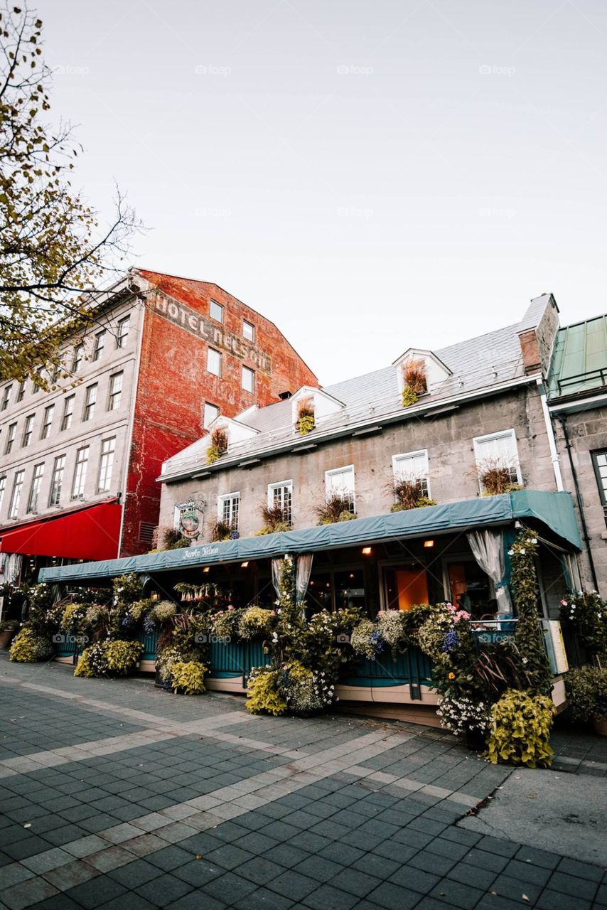 Cute restaurant in Montreal, Quebec full of greenery with quaint architecture