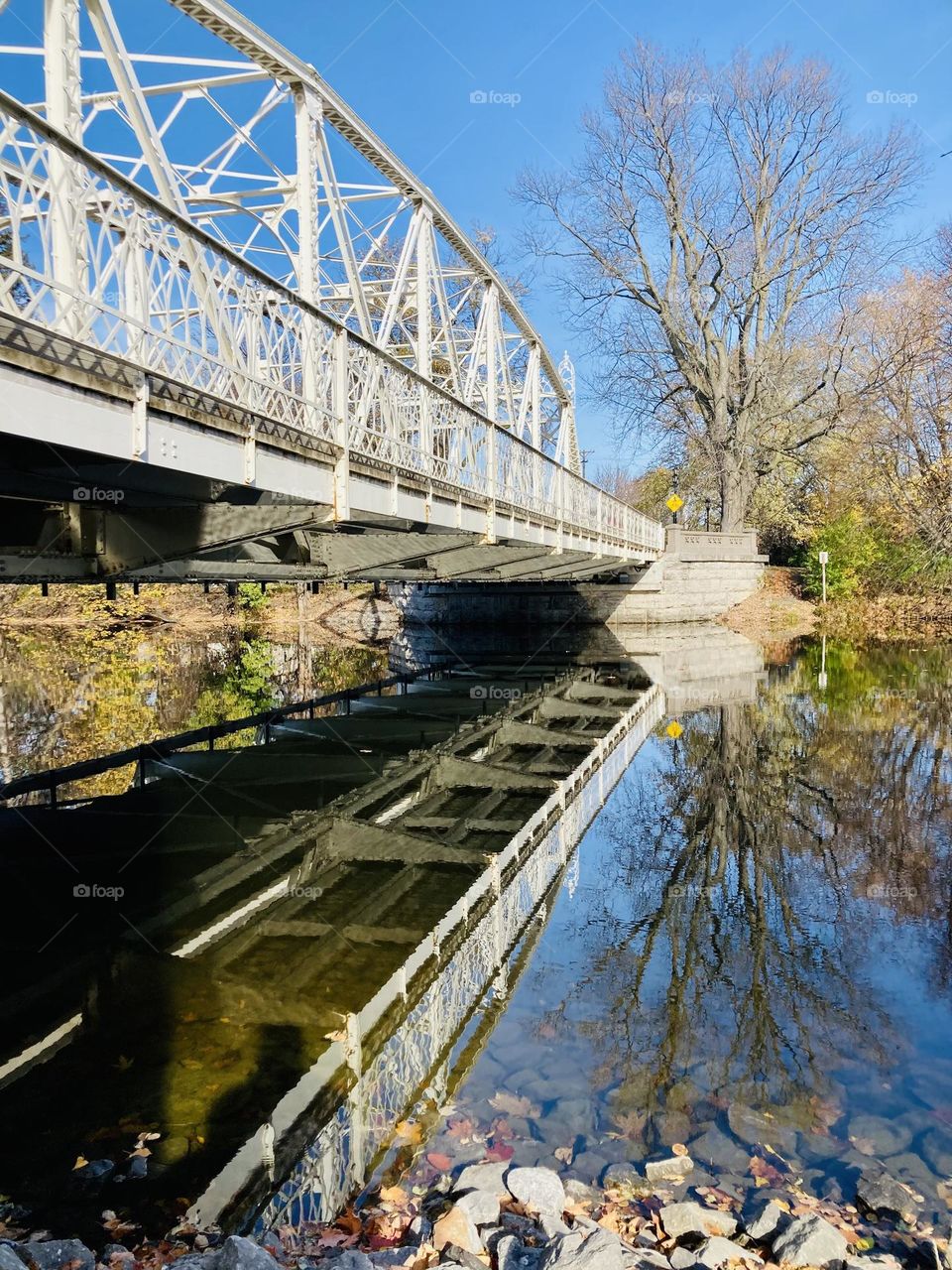 A fall reflection of the Union Street Bridge over the Rideau River.