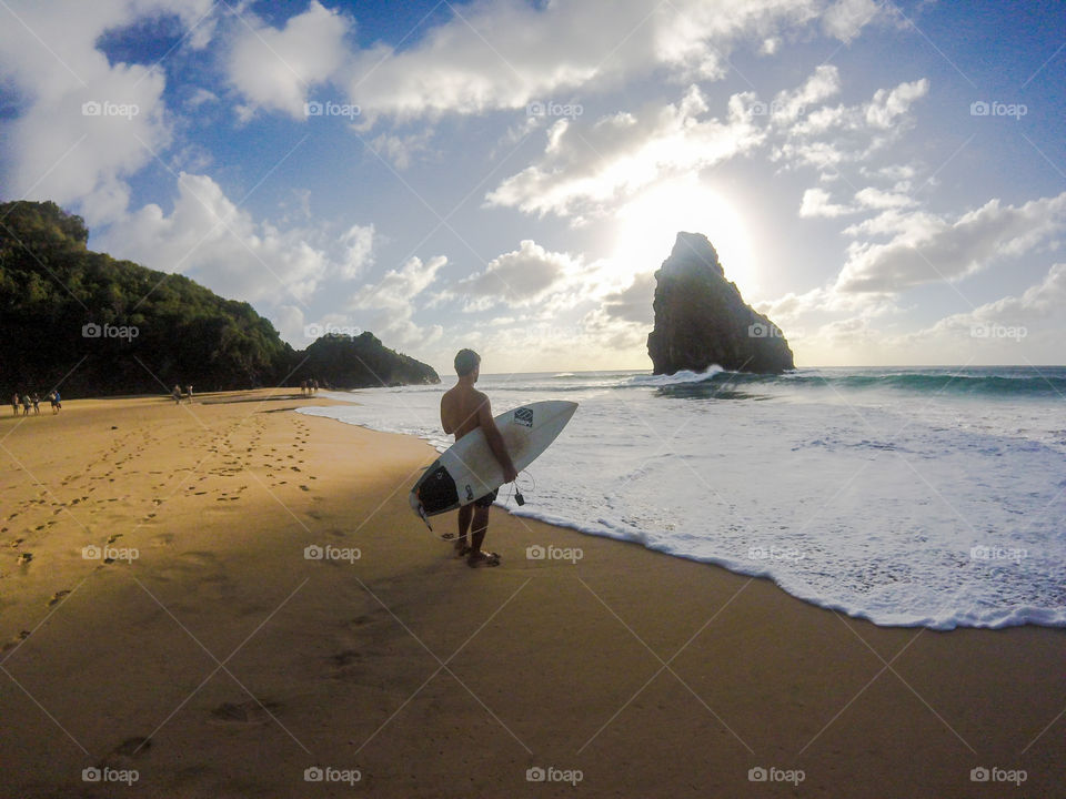 Fernando de Noronha beach. Man with surf. 
