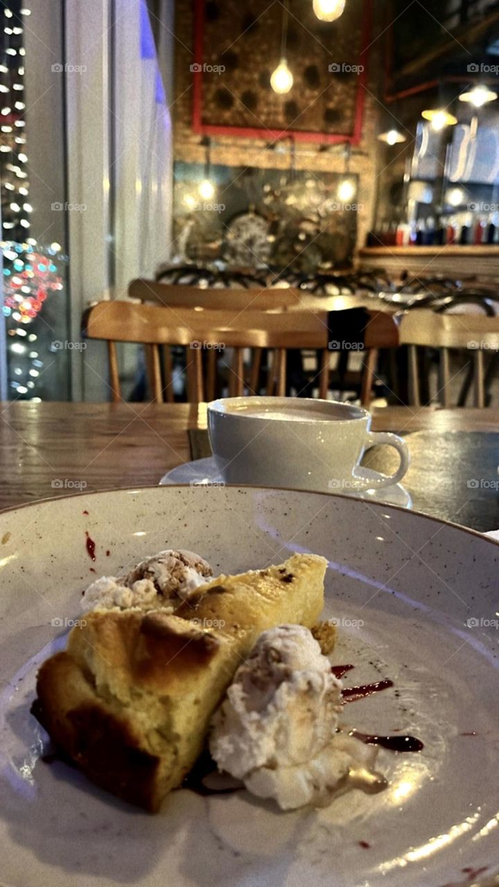 A good view at night and a delicious cheesecake with some hot coffee 