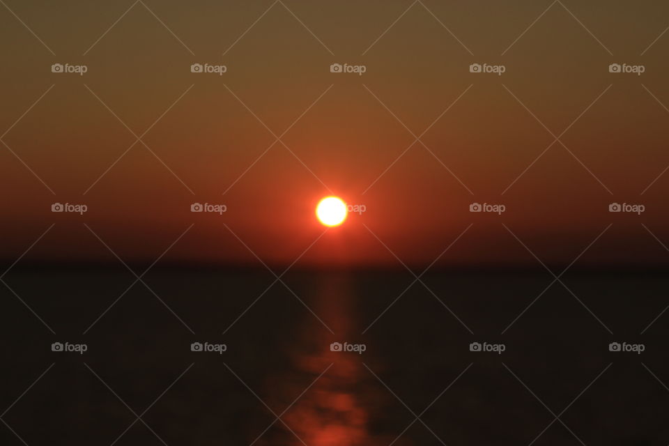 A deep red sunset out of focus