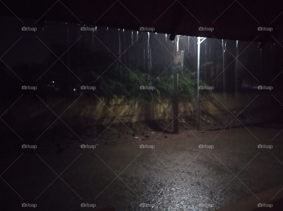 submitted this photo for mission rainy citie, a rainy night it's raining, lighting, water on the road